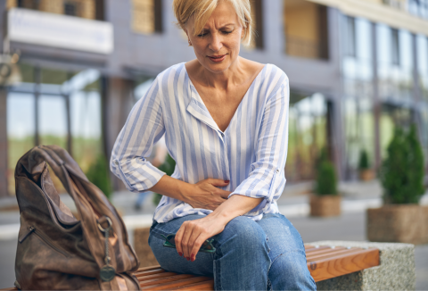 lady holding lower stomach in pain