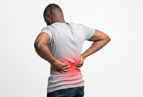 man leaning over with pain in lower back