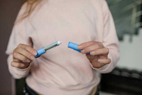 Woman holding a weight loss injection 