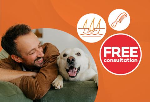 Man with a receding hair line smiling at his dog