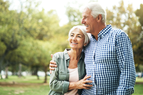 A happy senior couple in a park in the summer