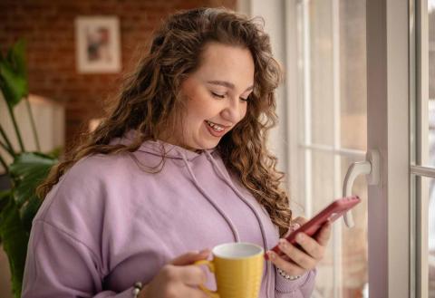 Happy young woman on her phone