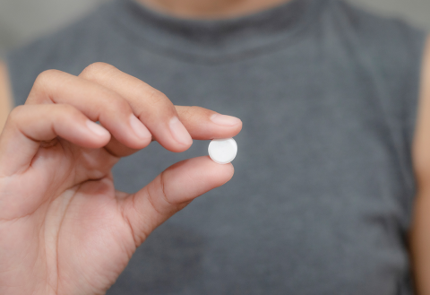 Man holding a pill