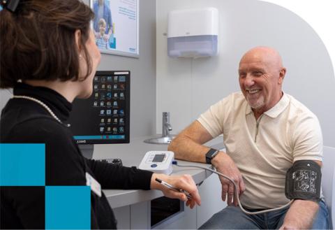 man getting his blood pressure checked at Rowlands Pharmacy